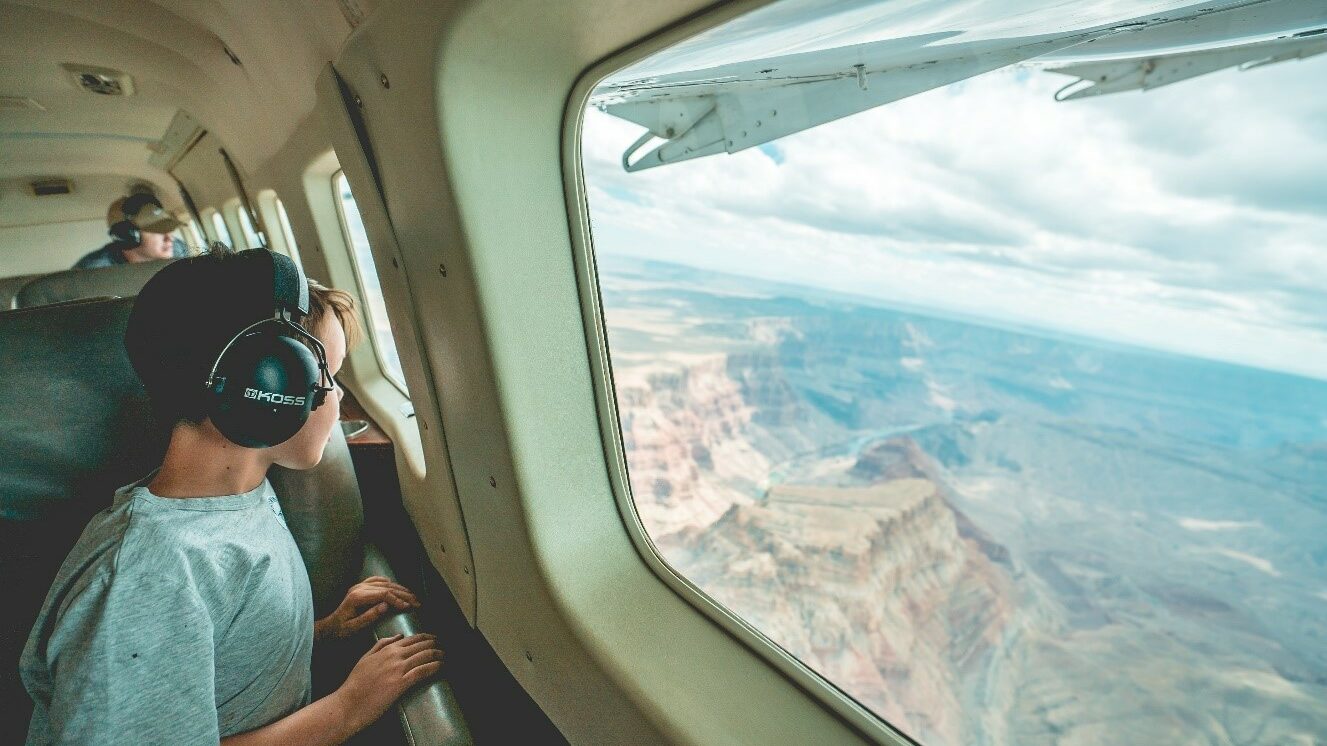 Travel tutors - child looks out of window of private plane